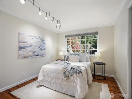 a bedroom with a large bed and a window