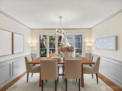 a dining room with furniture a chandelier and window