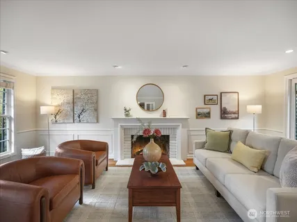 a living room with furniture a fireplace and window