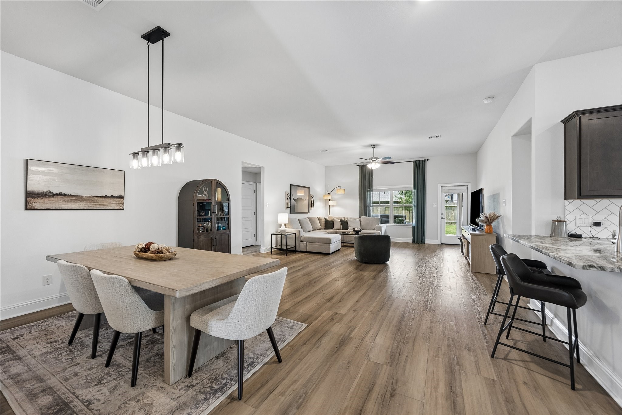 10227 Whitney Reach Drive Rosharon, TX 77583 - Photo 1 of 28 Discover a spacious open-concept living area with elegant flooring, seamlessly connected to a modern kitchen, offering endless possibilities.