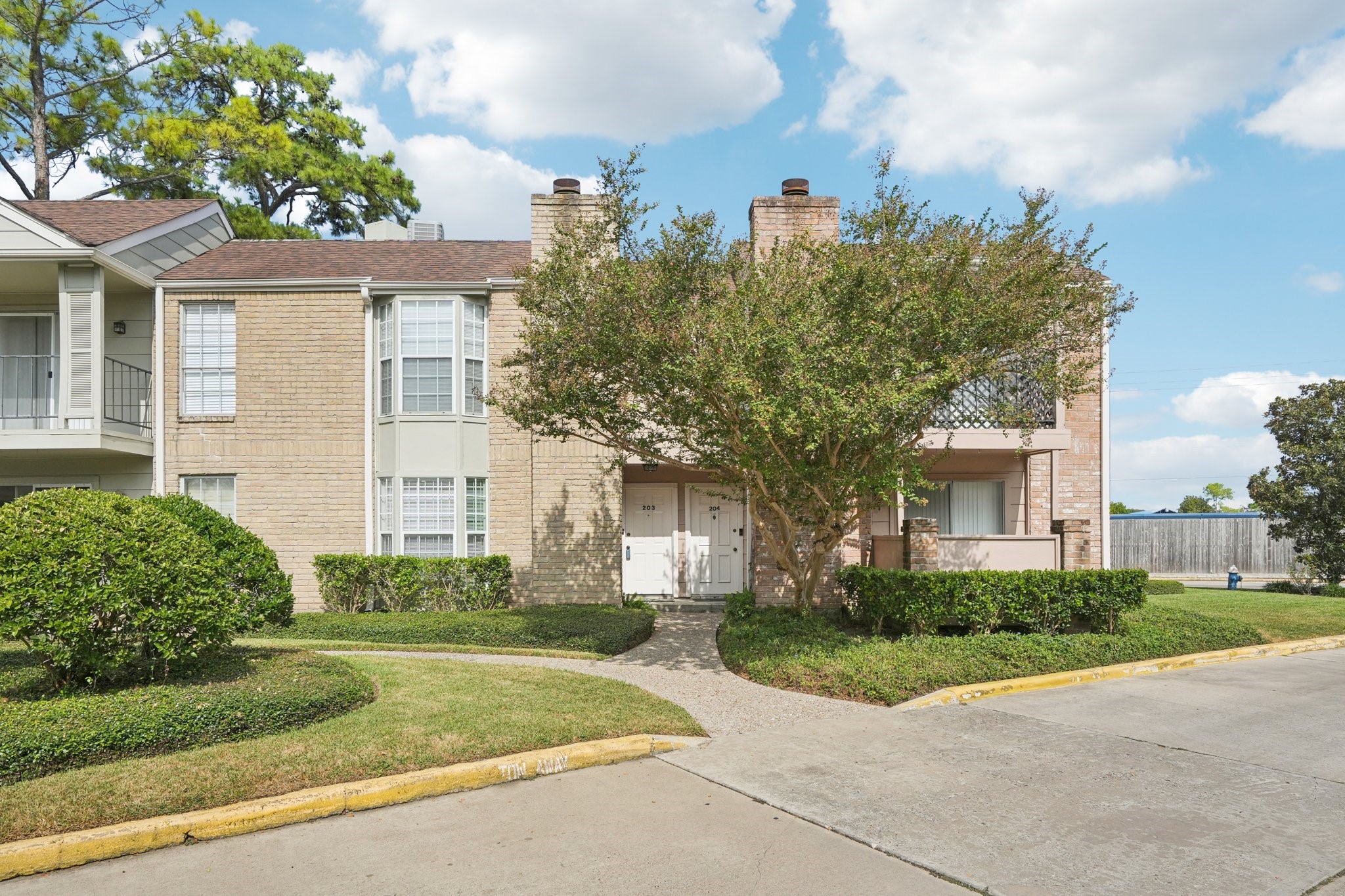 2800 Jeanetta Street, Unit 203 Houston, TX 77063 - Photo 1 of 34 a front view of a house with garden