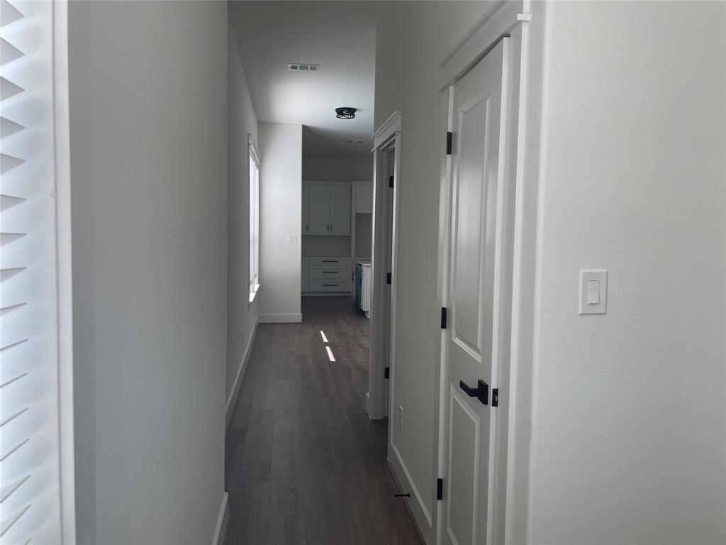 3535 Spring Avenue Dallas, TX 75210 - Photo 12 of 19 Hallway with baseboards and dark wood finished floors