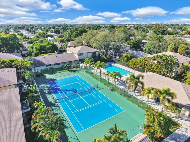 an aerial view of a house with a yard and garden