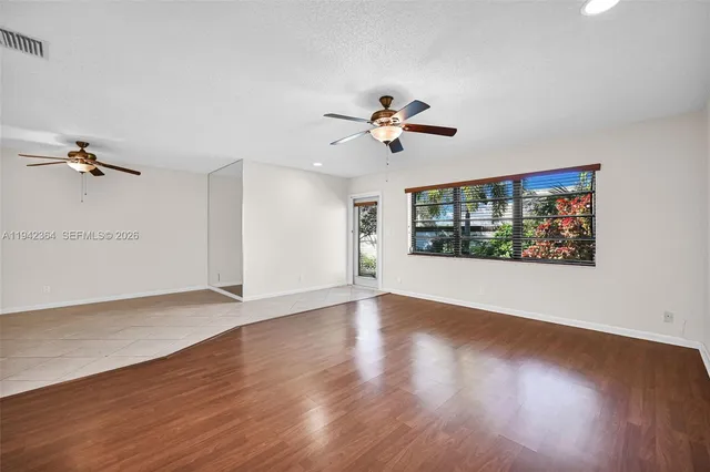 a view of room with hardwood floor and ceiling fan
