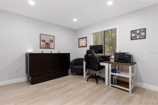 a view of a workspace with furniture and a window