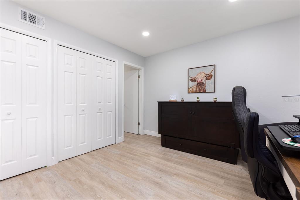 75 Southeast 16th Avenue, Unit A101 Gainesville, FL 32601 - Photo 12 of 24 a bedroom with a bed and wooden floor