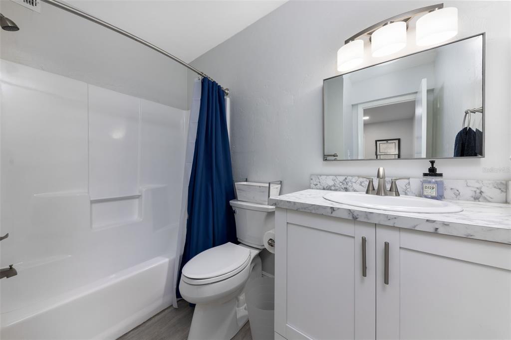 75 Southeast 16th Avenue, Unit A101 Gainesville, FL 32601 - Photo 13 of 24 a bathroom with a granite countertop sink toilet and shower