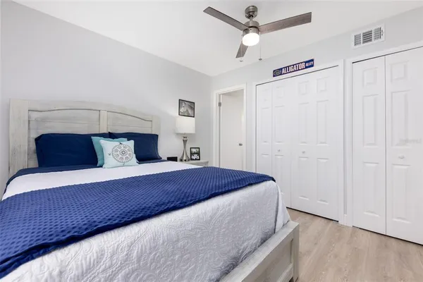 a bedroom with a bed and a ceiling fan