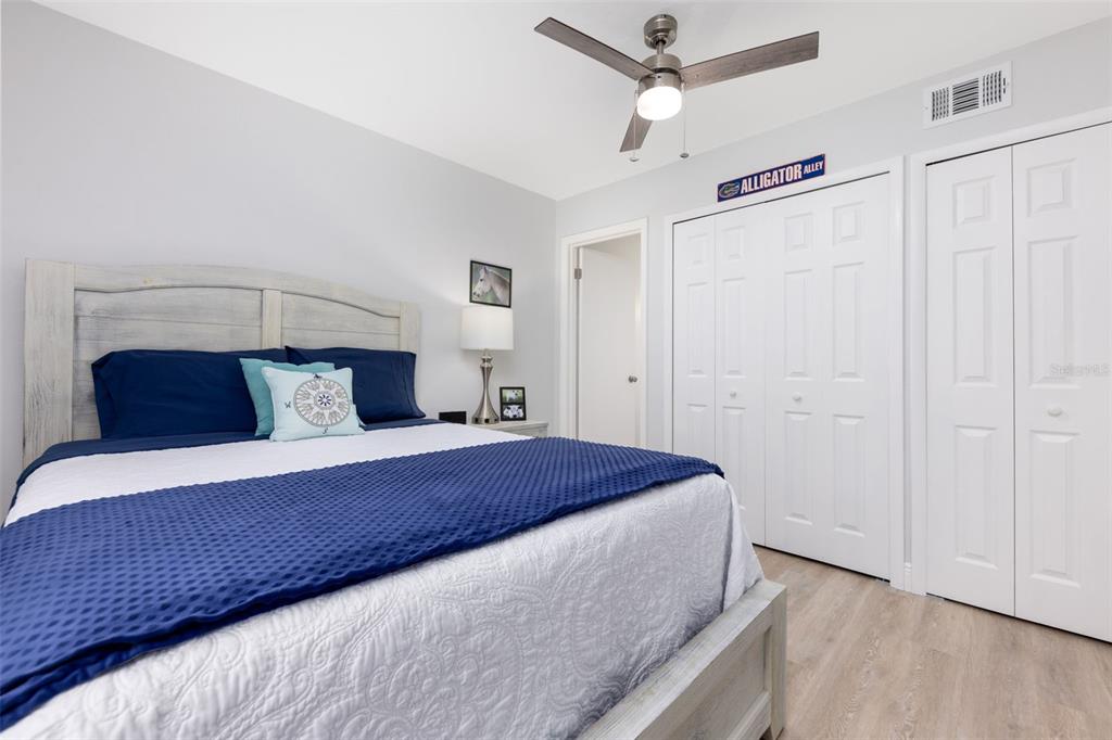 75 Southeast 16th Avenue, Unit A101 Gainesville, FL 32601 - Photo 15 of 24 a bedroom with a bed and a ceiling fan