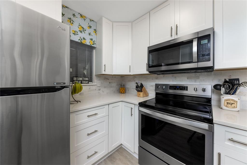 75 Southeast 16th Avenue, Unit A101 Gainesville, FL 32601 - Photo 5 of 24 a kitchen with stainless steel appliances a stove a microwave and cabinets