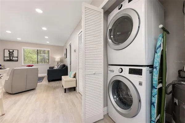 a living room with furniture and a washer dryer