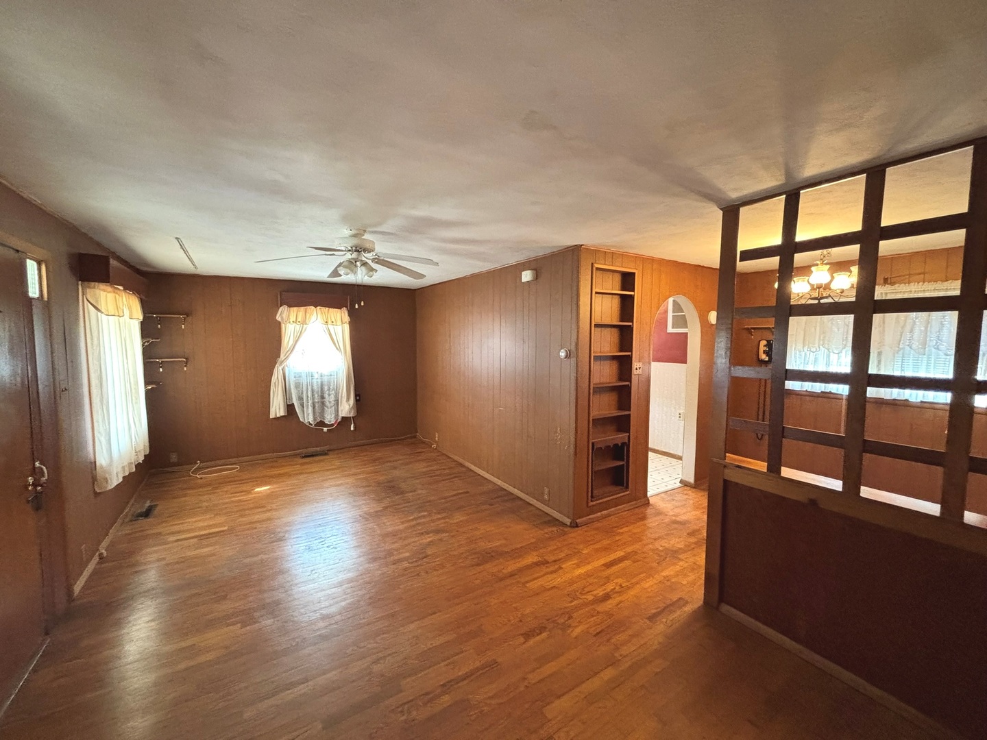 107 Dewolf Street Odin, IL 62870 - Photo 2 of 10 a view of an empty room with window and wooden floor