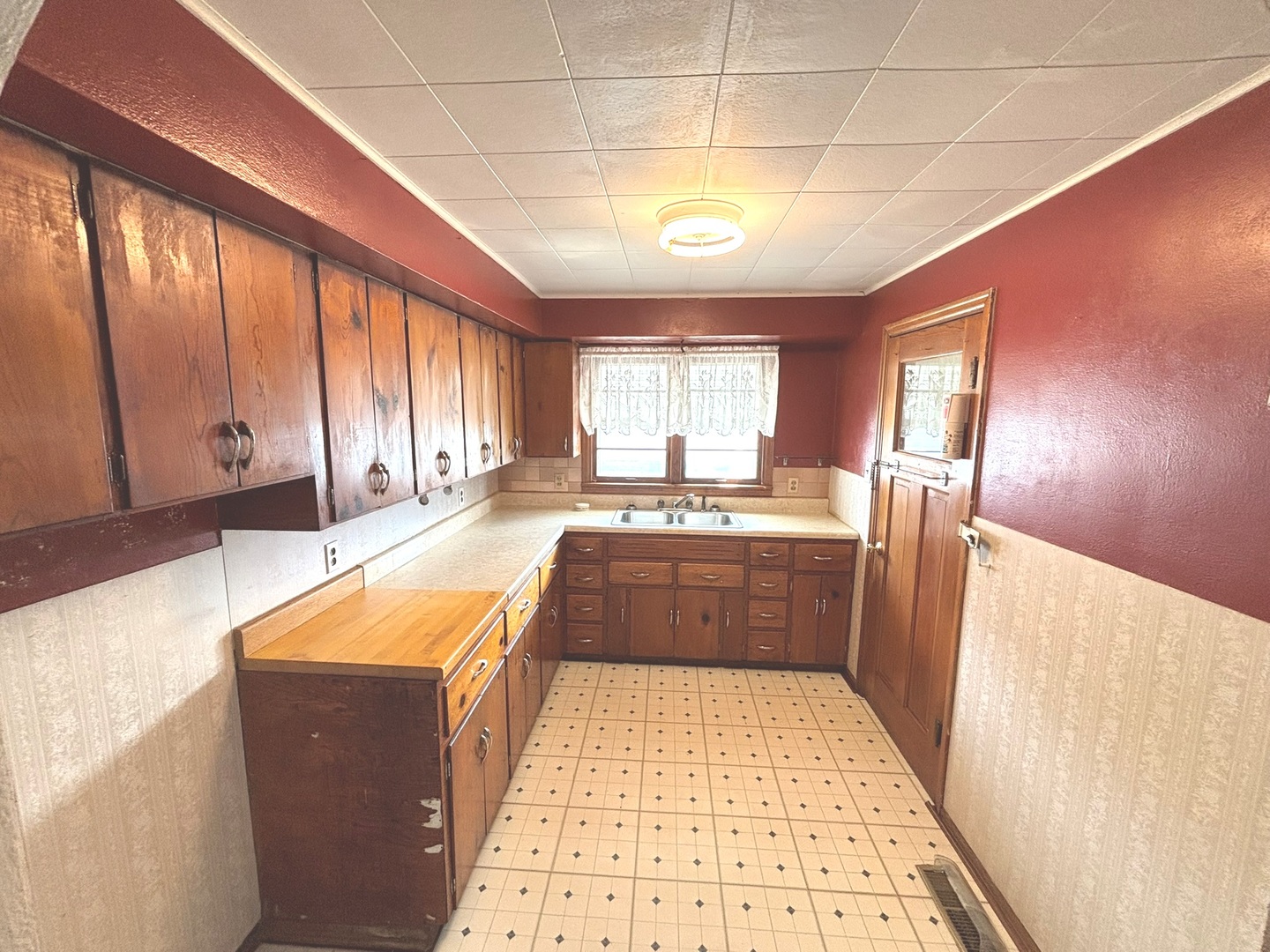 107 Dewolf Street Odin, IL 62870 - Photo 5 of 10 a large kitchen with stainless steel appliances granite countertop a refrigerator a sink dishwasher and wooden cabinets with wooden floor