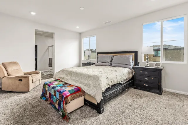 a bedroom with a bed and a couch