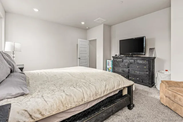 a bedroom with a bed and a flat screen television