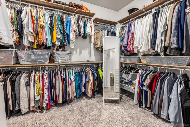 a view of walk in closet with clothes