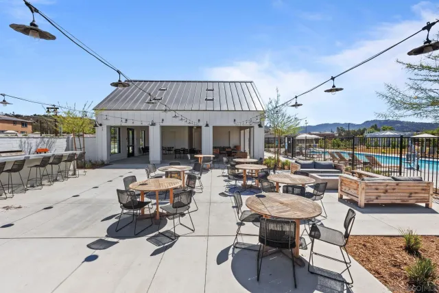 a living room with patio furniture and a potted plant