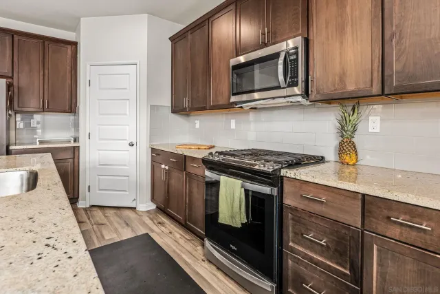 a kitchen with a stove microwave and sink