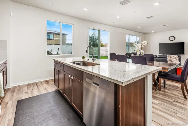 a kitchen with a stove a counter space and a center island