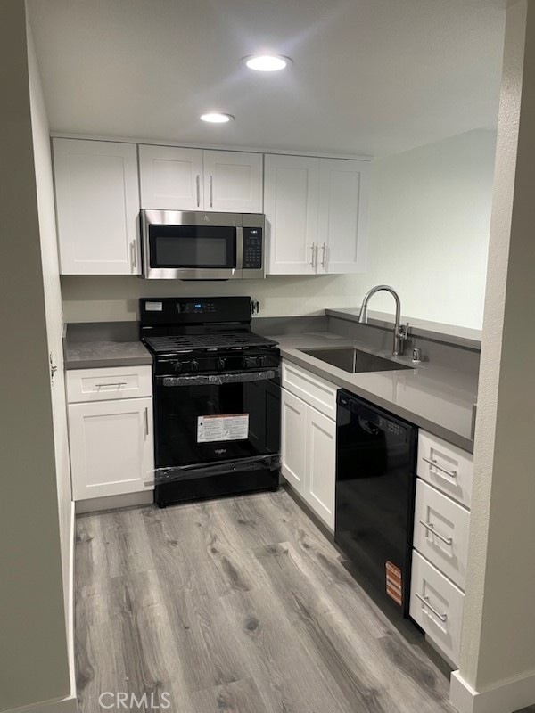 a kitchen with stainless steel appliances granite countertop a stove a microwave and a sink