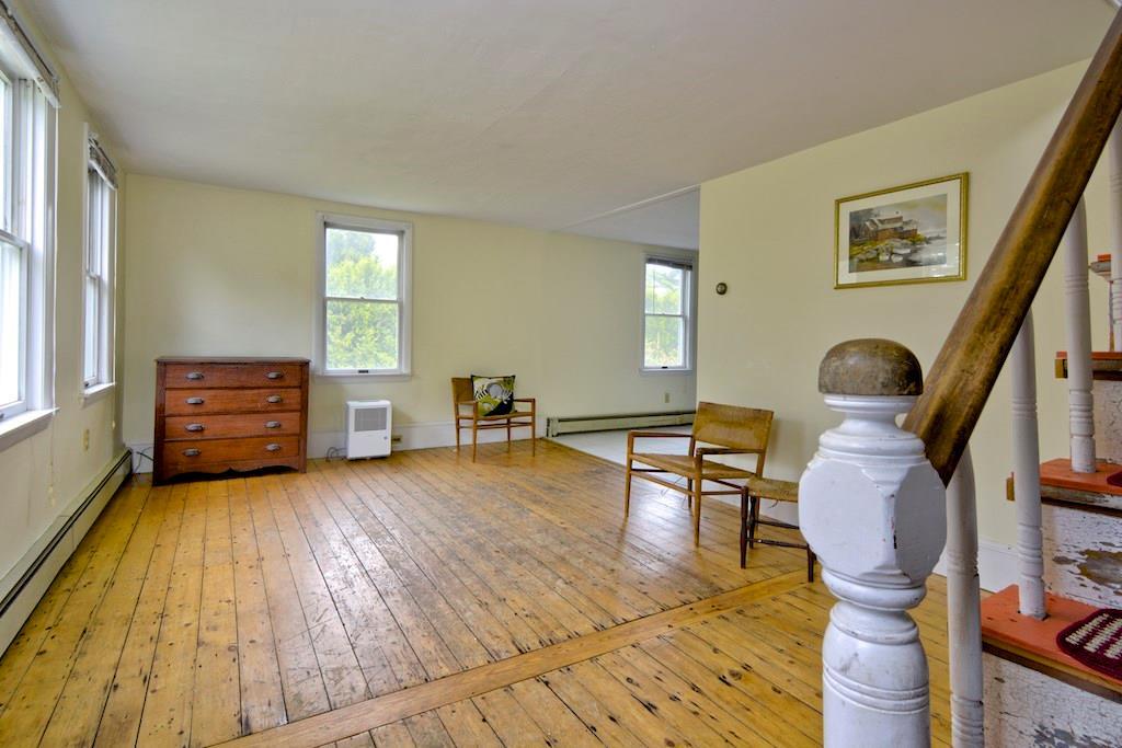 335 River Road Tenants Harbor, ME 04860 - Photo 4 of 12 Living room open to eat-in kitchen.