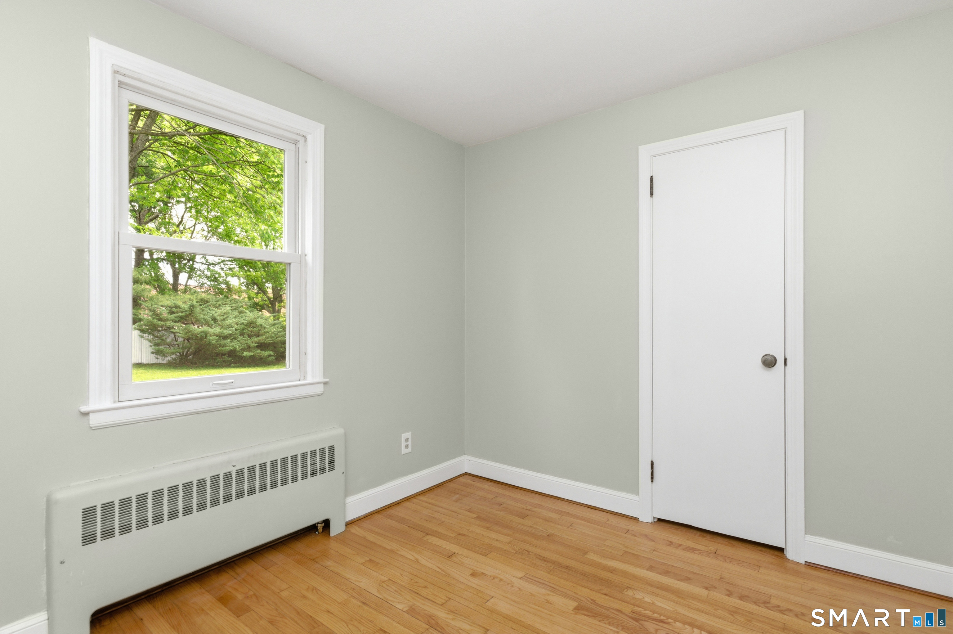 149 Mill Street Wethersfield, CT 06109 - Photo 14 of 29 a view of an empty room with wooden floor and a window