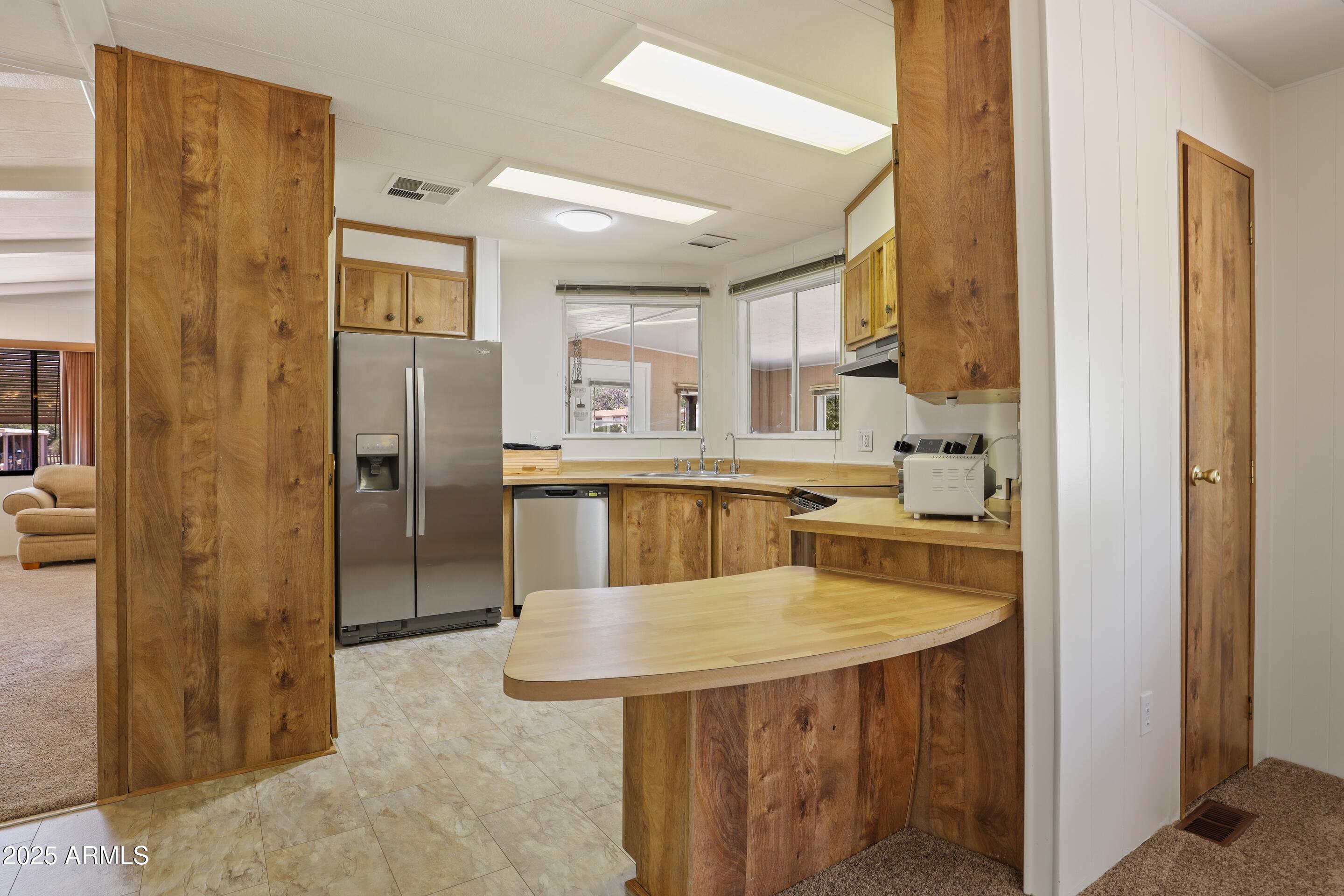 117 South Lakeshore Road Payson, AZ 85541 - Photo 10 of 33 a kitchen with stainless steel appliances kitchen island a refrigerator and a sink