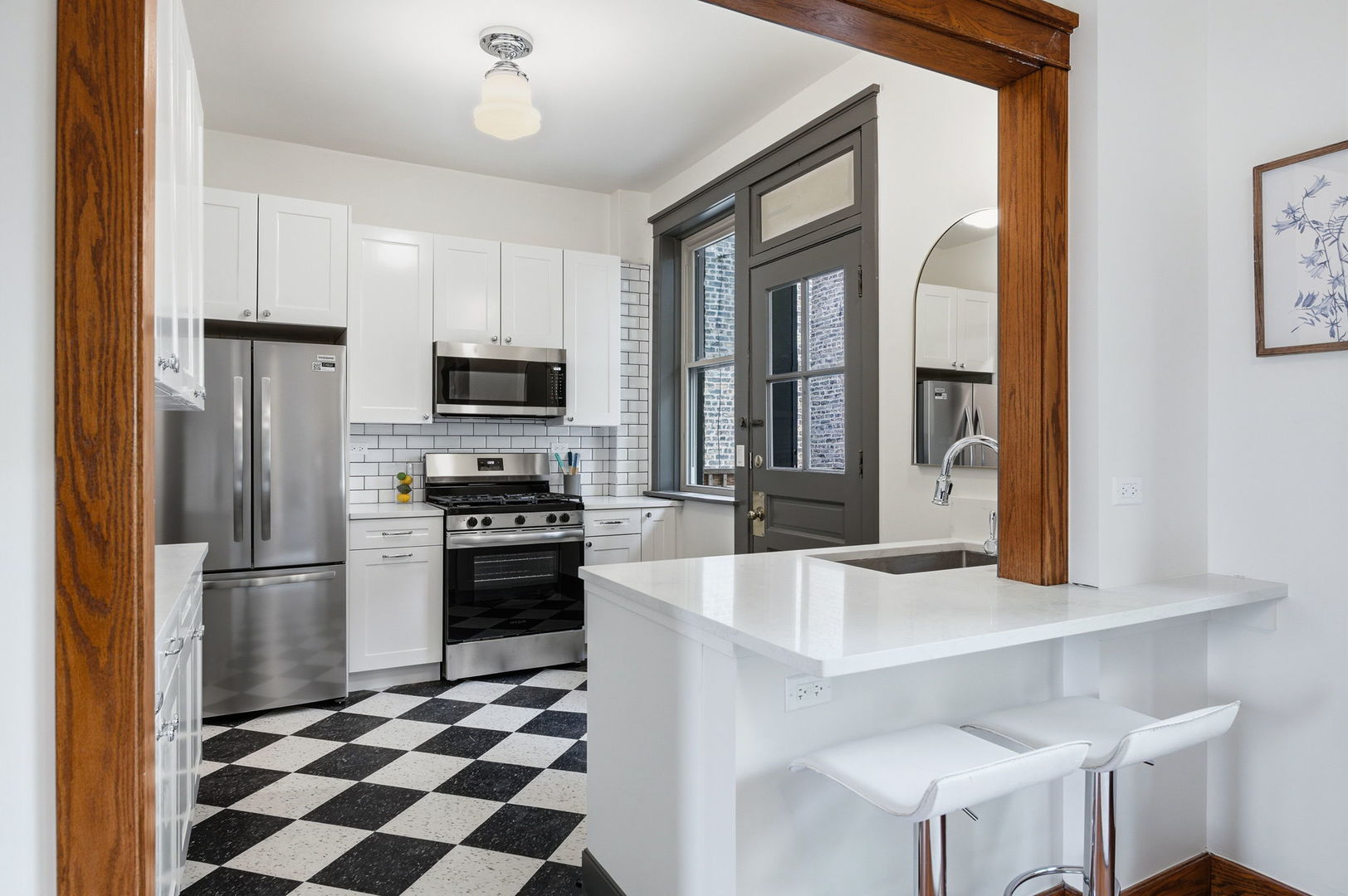 2920 West Altgeld Street, Unit 2 Chicago, IL 60647 - Photo 9 of 22 a kitchen with granite countertop stainless steel appliances a refrigerator and a stove top oven