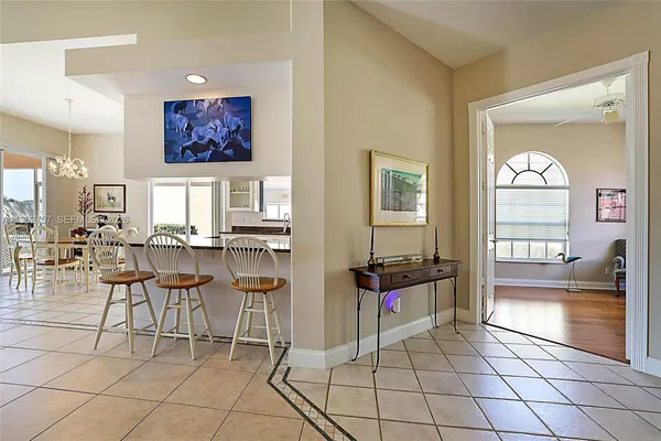 a living room with furniture a dining table and a painting on the wall