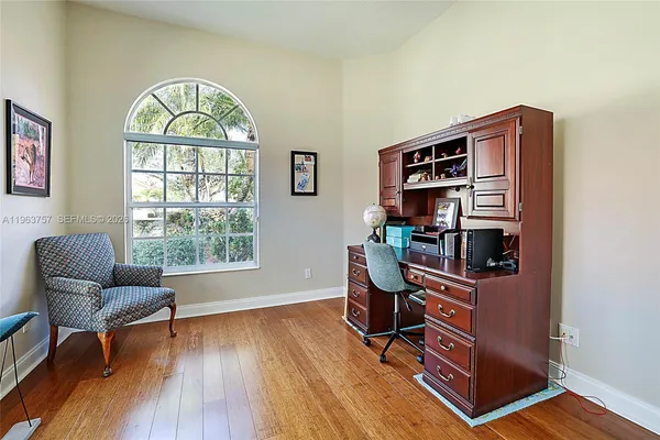 a workspace with lounge chair and a window