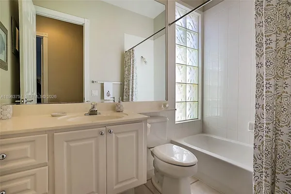a bathroom with a double vanity sink toilet and a mirror