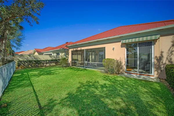 a view of a house with a backyard
