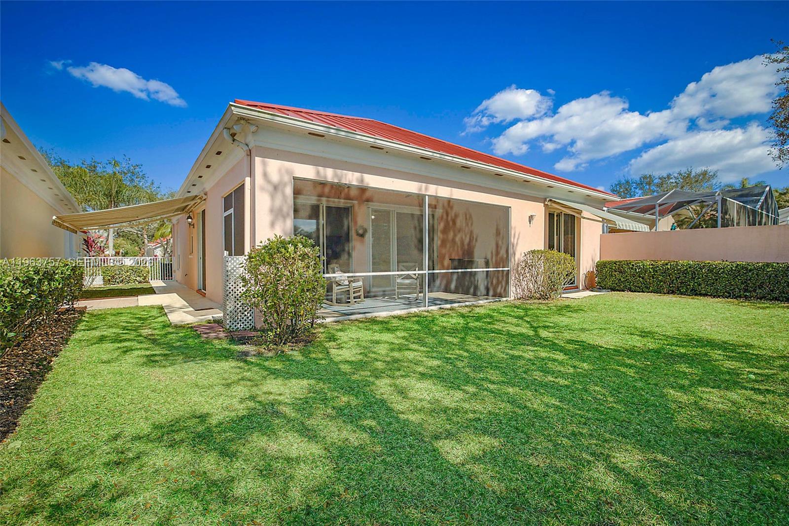 1226 Southwest Eagleglen Place Stuart, FL 34997 - Photo 37 of 45 Additional patios off the primary bedroom and kitchen have extended automated awnings for when you wish to enjoy more outdoor space.