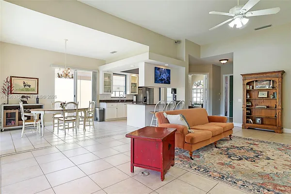 a living room with furniture a dining table and chairs