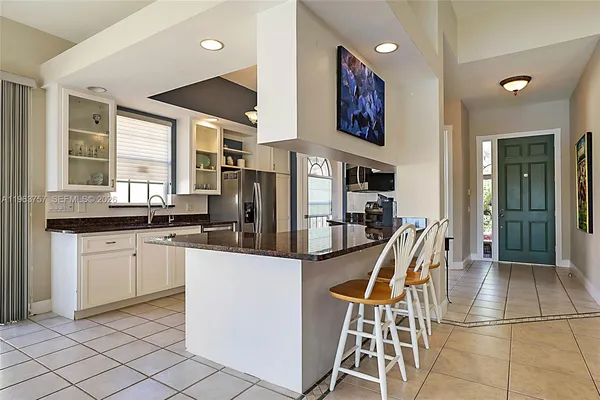 a kitchen with stainless steel appliances kitchen island granite countertop a sink and cabinets