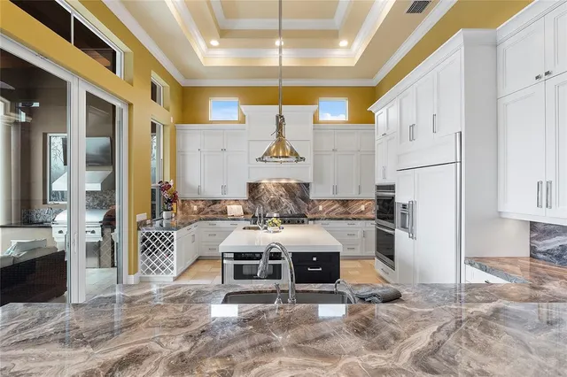 a spacious bathroom with a granite countertop sink a large mirror and shower