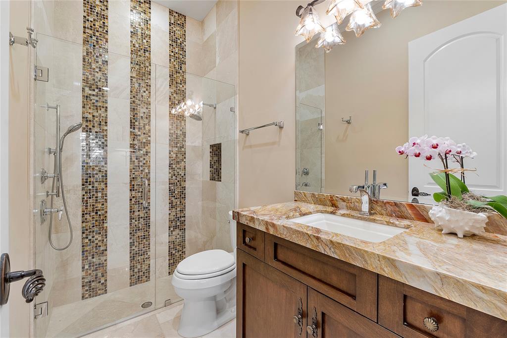 3430 Northeast 23rd Avenue Lighthouse Point, FL 33064 - Photo 30 of 44 a bathroom with a granite countertop sink toilet and shower