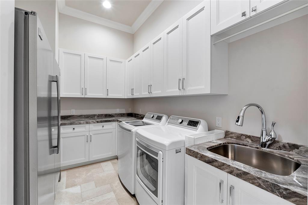 3430 Northeast 23rd Avenue Lighthouse Point, FL 33064 - Photo 37 of 44 a kitchen with stainless steel appliances granite countertop a sink stove and white cabinets