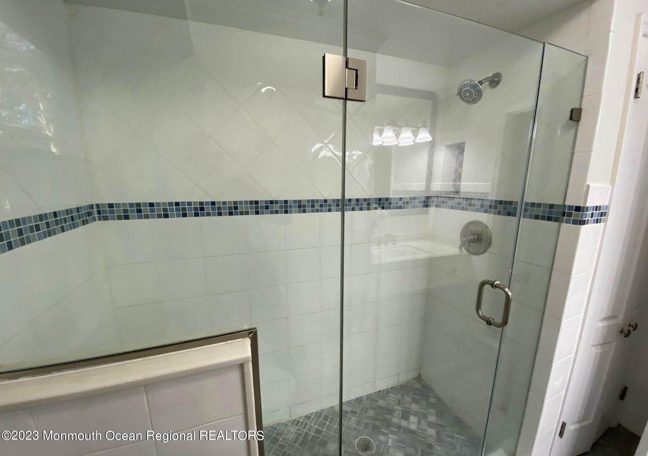 26 Van Brackle Road Holmdel, NJ 07733 - Photo 14 of 36 a bathroom with a shower and a mirror