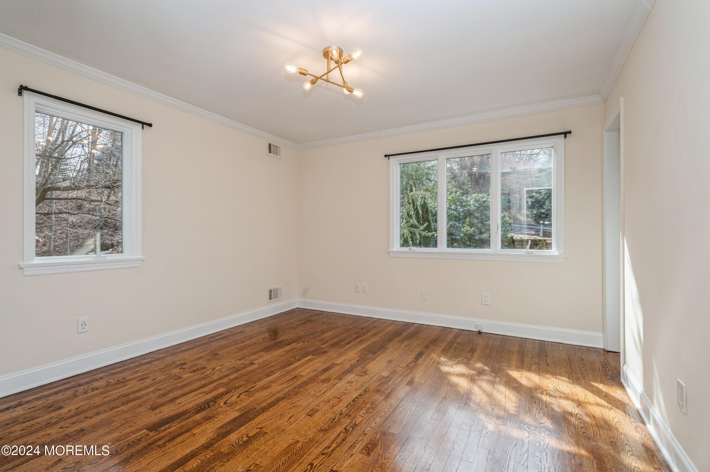 26 Van Brackle Road Holmdel, NJ 07733 - Photo 15 of 36 a view of empty room with wooden floor and fan