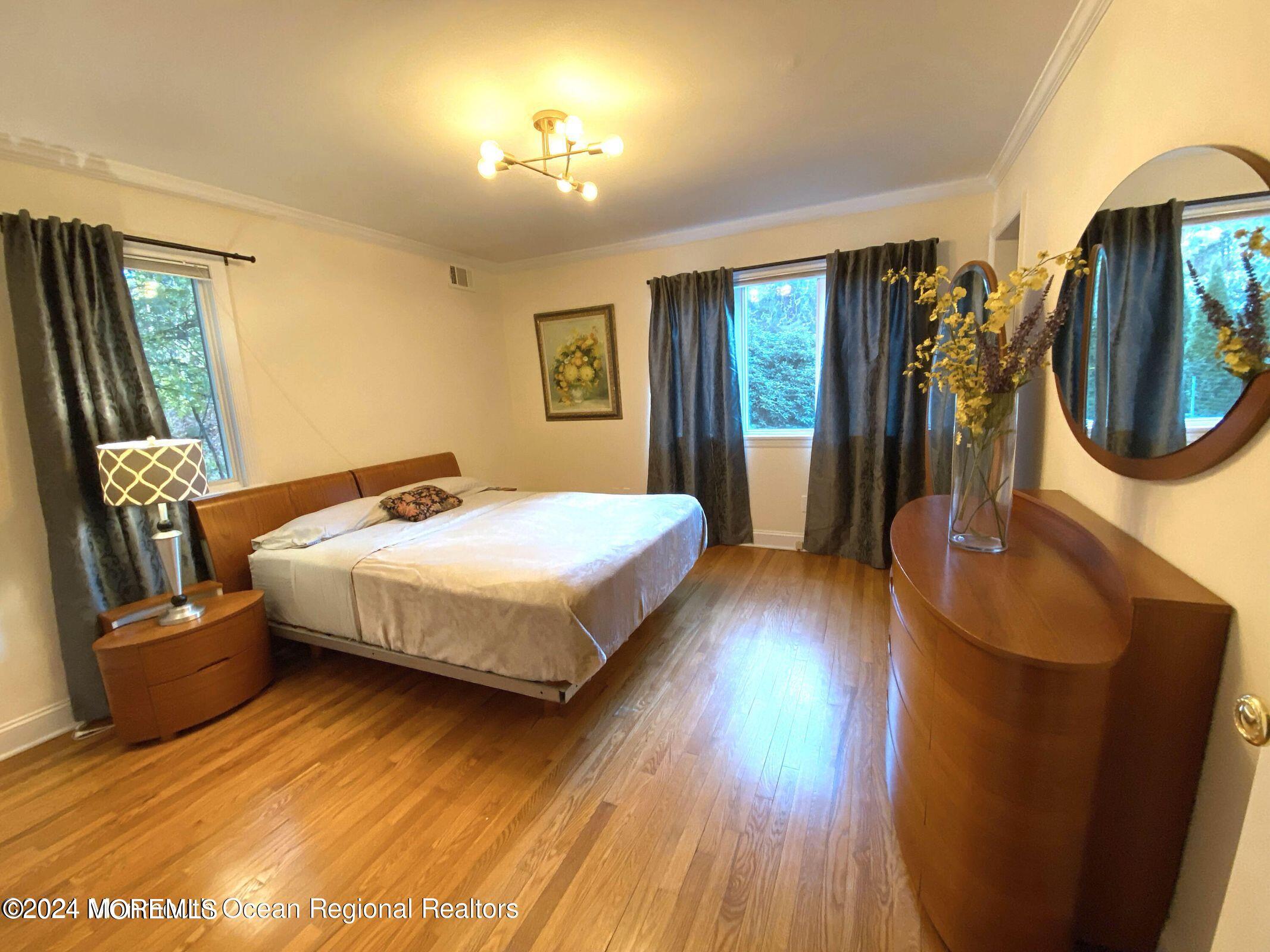 26 Van Brackle Road Holmdel, NJ 07733 - Photo 16 of 36 a bedroom with a bed lamps and mirror