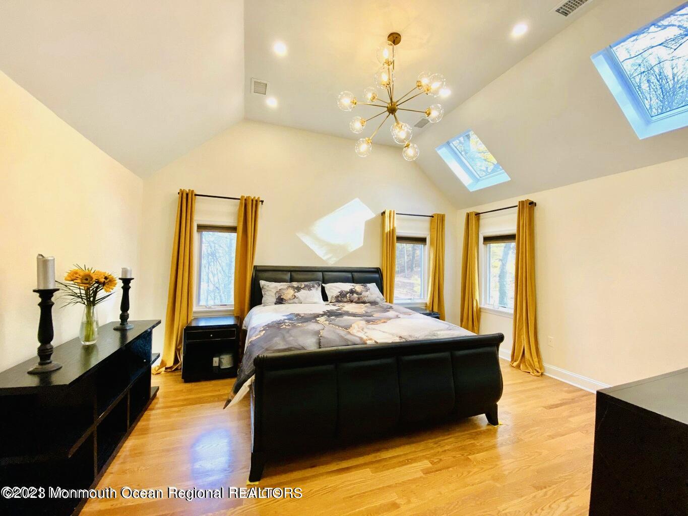 26 Van Brackle Road Holmdel, NJ 07733 - Photo 22 of 36 a bed room with a bed and a chandelier