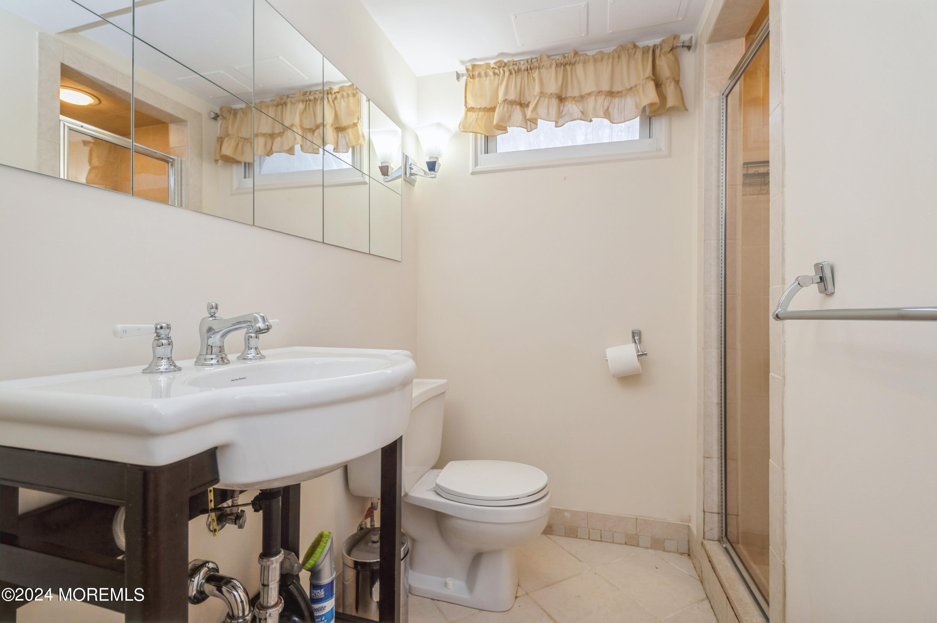 26 Van Brackle Road Holmdel, NJ 07733 - Photo 27 of 36 a bathroom with a sink and a toilet