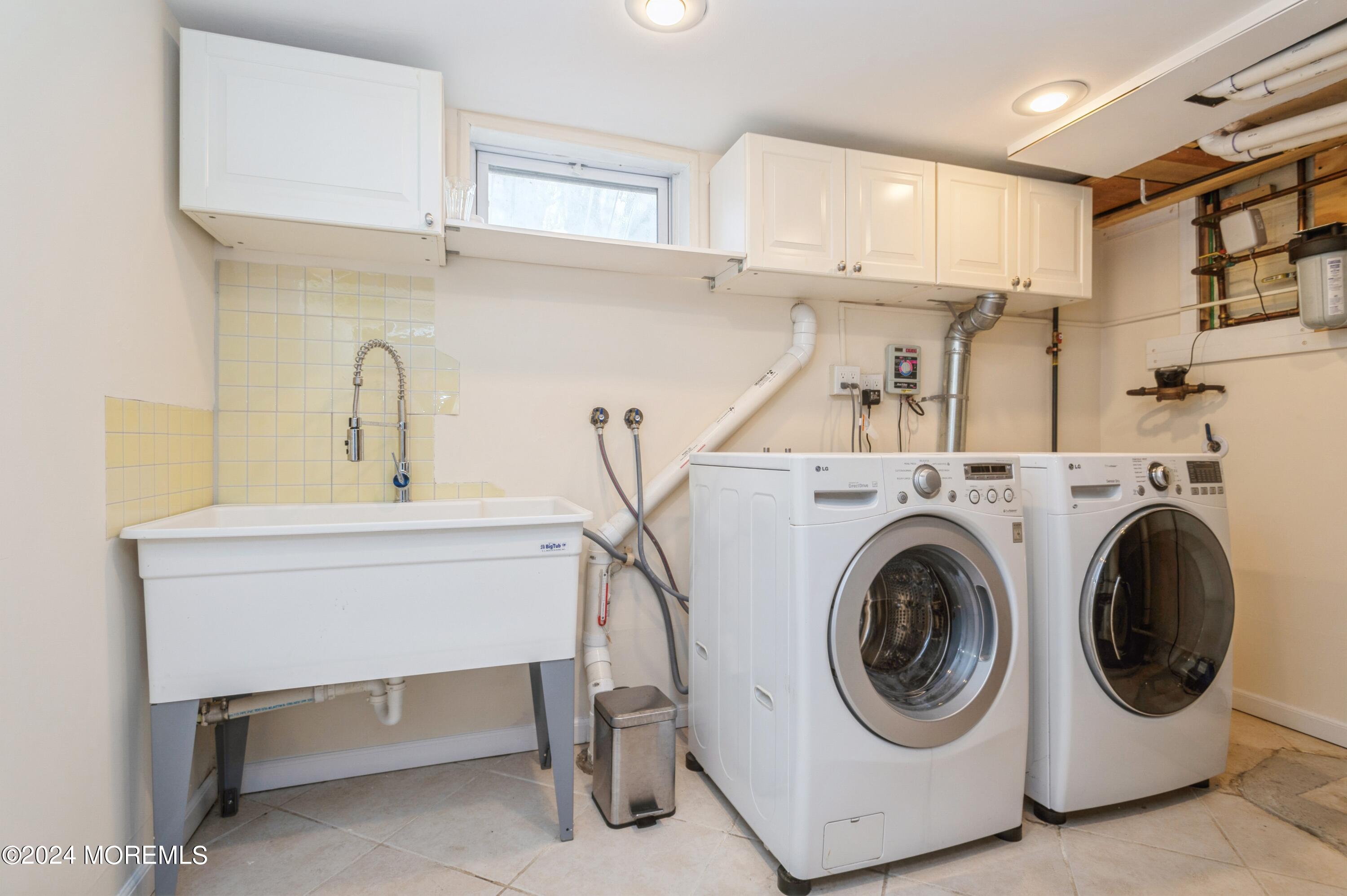 26 Van Brackle Road Holmdel, NJ 07733 - Photo 28 of 36 a utility room with cabinets dryer and washer