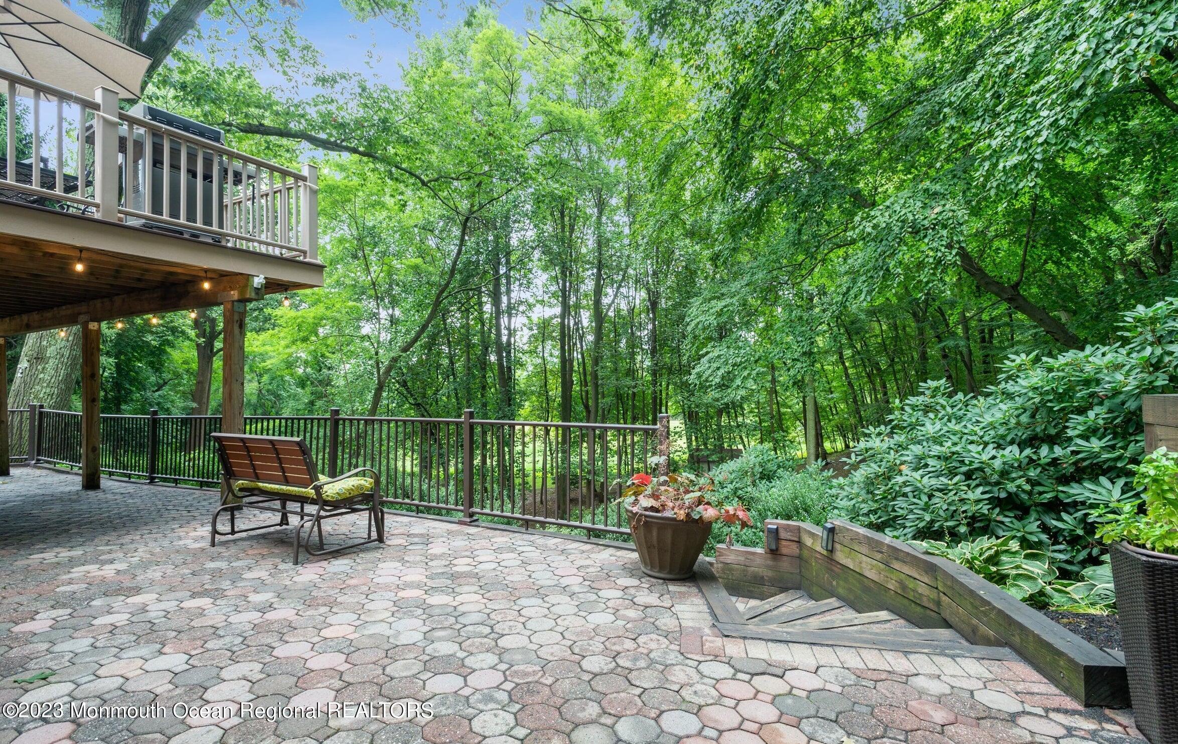 26 Van Brackle Road Holmdel, NJ 07733 - Photo 31 of 36 a view of a chairs and table in the back yard of the house