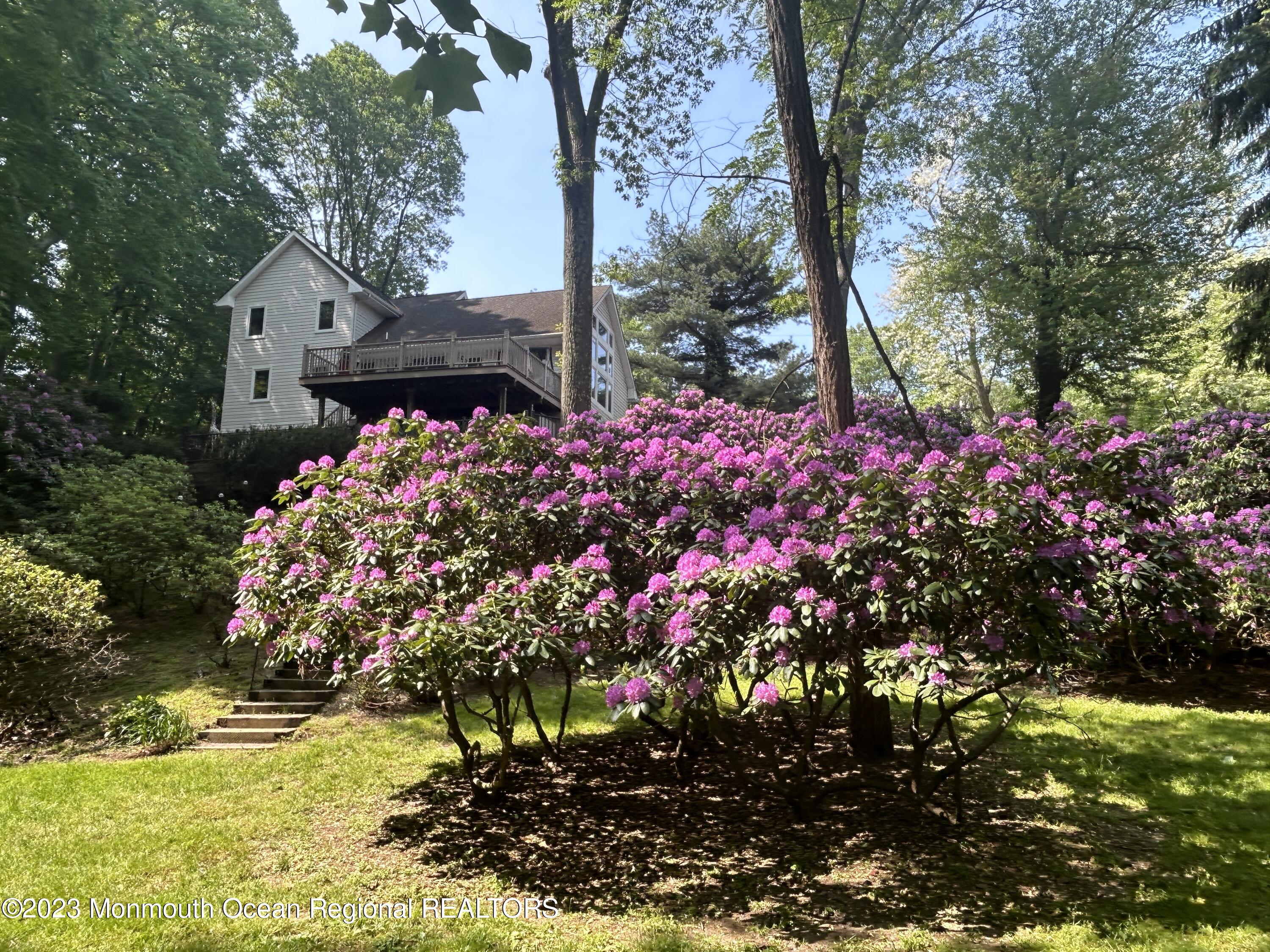 26 Van Brackle Road Holmdel, NJ 07733 - Photo 32 of 36 a front view of a house with a yard and fountain