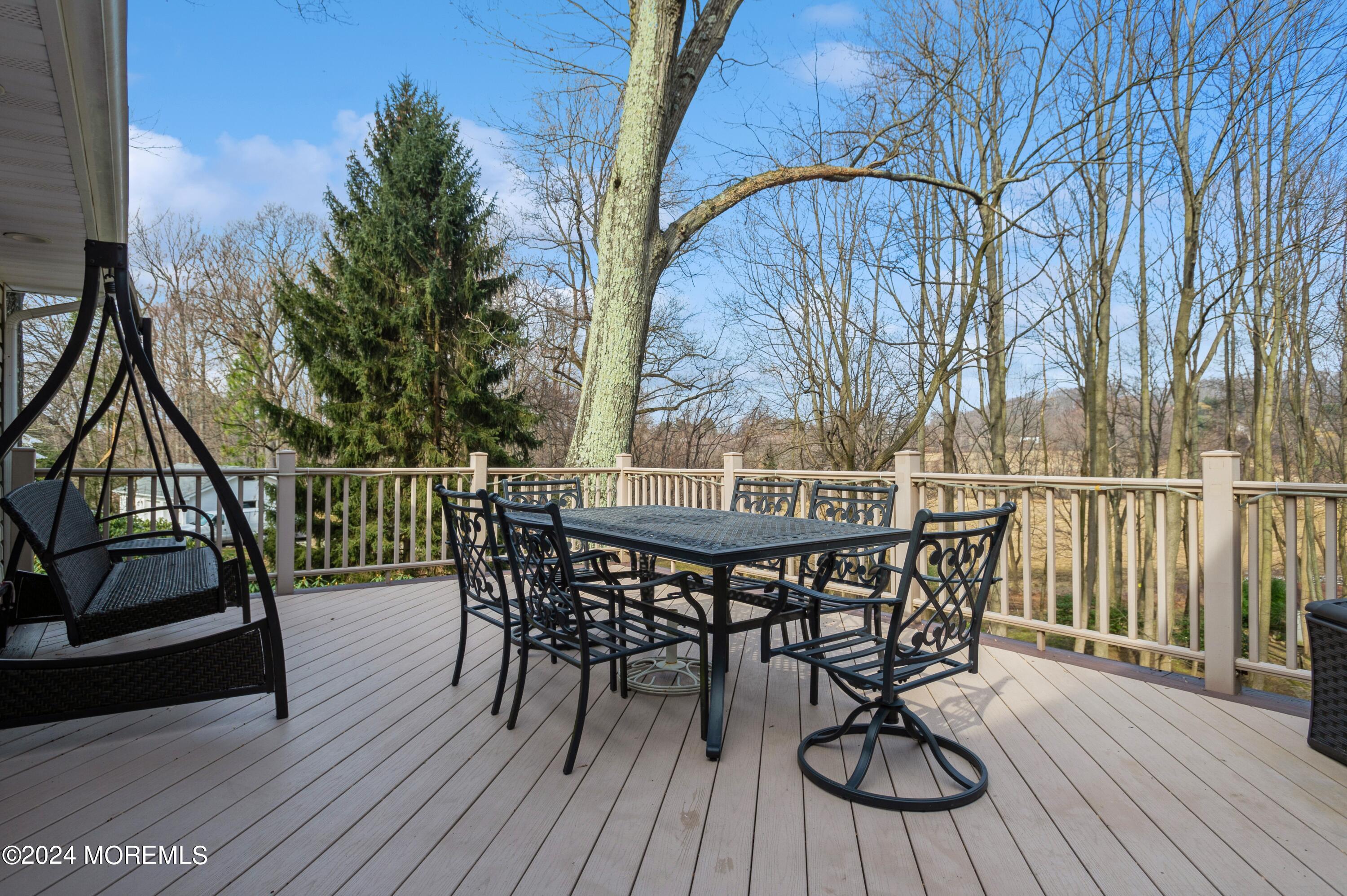 26 Van Brackle Road Holmdel, NJ 07733 - Photo 7 of 36 a view of balcony with wooden floor and outdoor seating