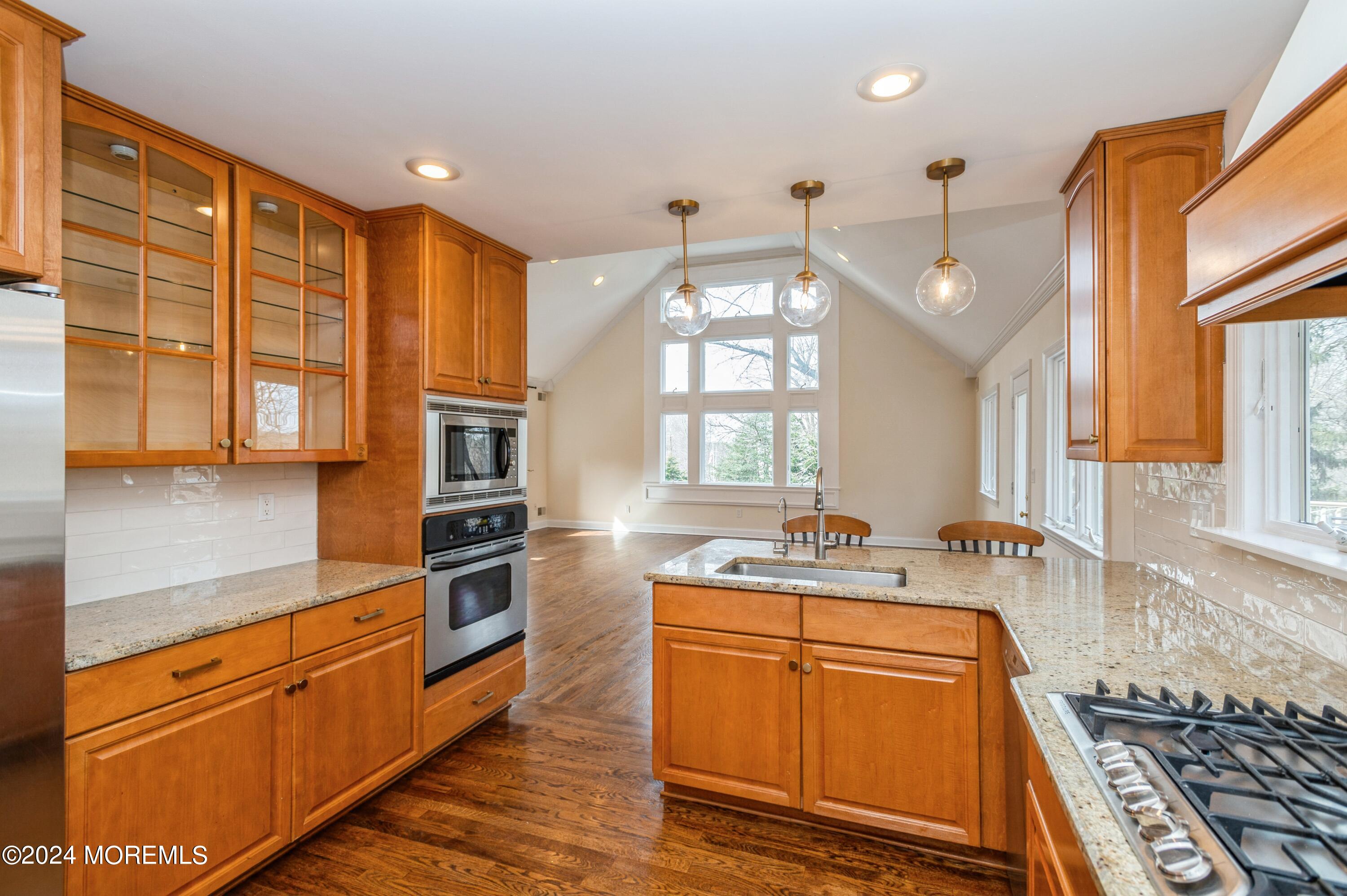 26 Van Brackle Road Holmdel, NJ 07733 - Photo 9 of 36 a kitchen with stainless steel appliances granite countertop a stove a sink and a refrigerator