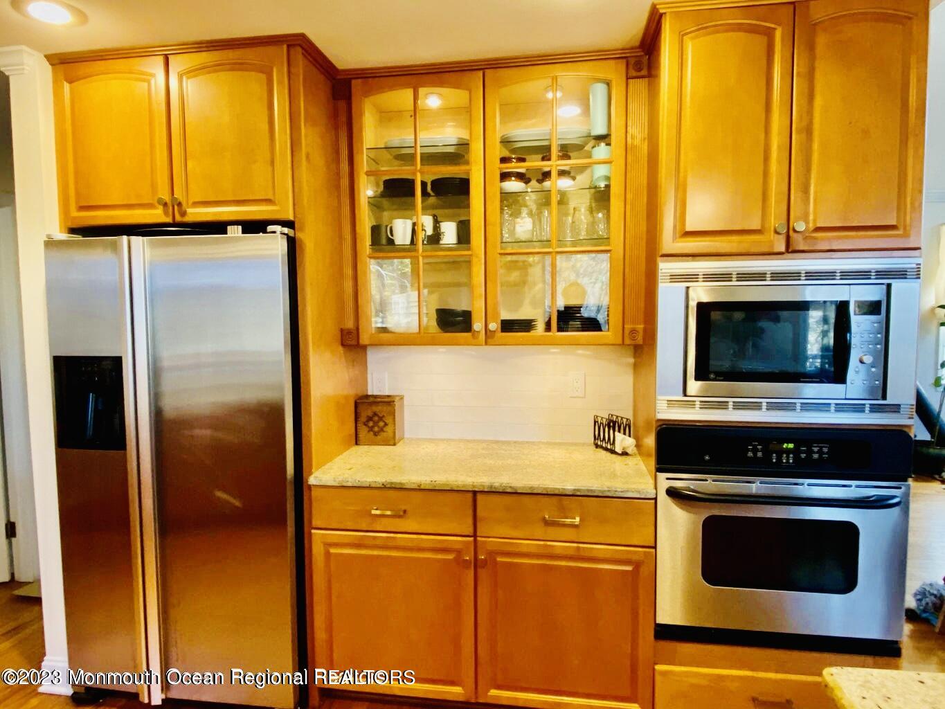 26 Van Brackle Road Holmdel, NJ 07733 - Photo 10 of 36 a kitchen with a refrigerator and a stove