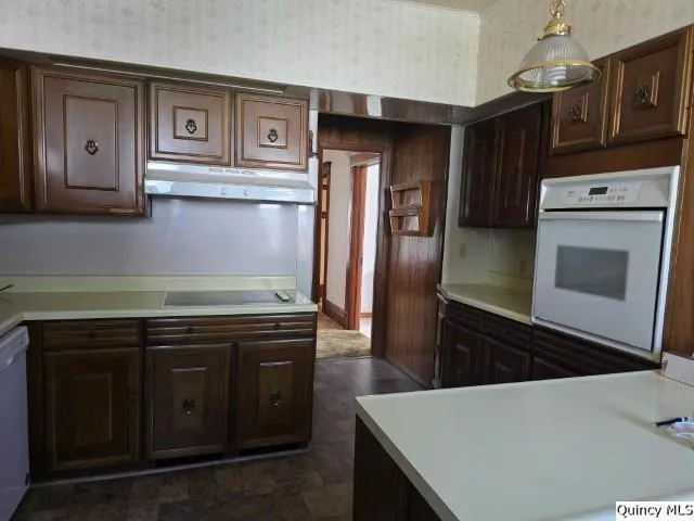 a kitchen with stainless steel appliances granite countertop a stove and a refrigerator